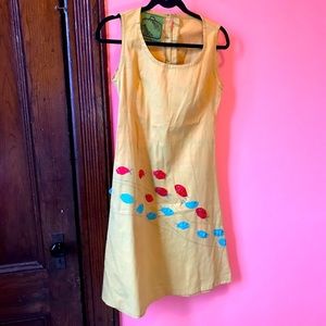 Cute green dress with fabric fish sewn on, sexy back buttons